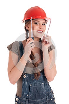 Young playful worker woman holding tape measure