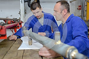 Young plumber and manager