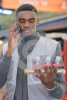 Young plumber on phone in harware store