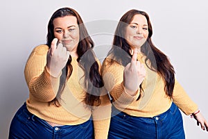 Young plus size twins wearing casual clothes beckoning come here gesture with hand inviting welcoming happy and smiling