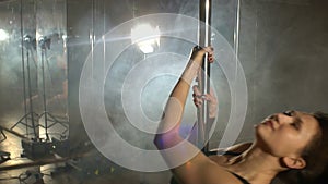 Young pole dance woman with long flowing hair.