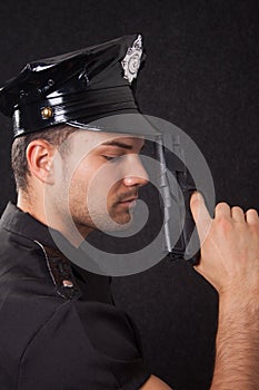 Young policeman looking down