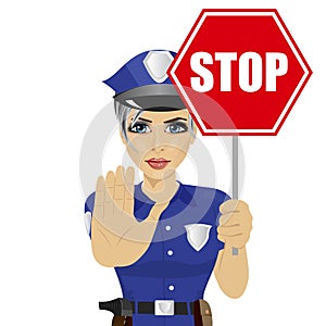Young policewoman holding stop sign and showing stop gesture