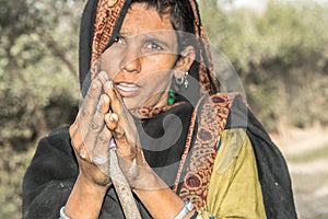 A young poor lady is begging cause of poverty