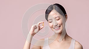 Portrait young asian woman happy smile face with vitamin nourishment pill. Pretty cute girl female person holding health capsule