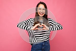 Young positive adorable happy amiling attractive brunette woman with sincere emotions wearing casual striped pullover