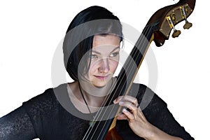 Young positive brunette playing double bass Isolated image on white background