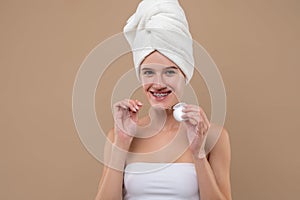 Young positive girl cleaning her teeth with a dental floss