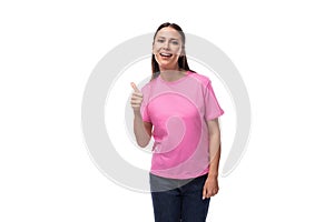 young positive happy slim woman dressed in a pink t-shirt. corporate clothing concept