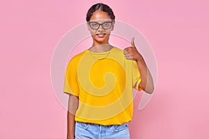 Young positive Indian woman teenager making approving gesture stands in studio