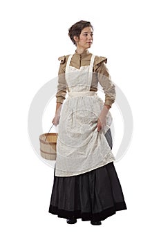 Young prairie woman with apron looking back and holding skirt and a basket isolated on white