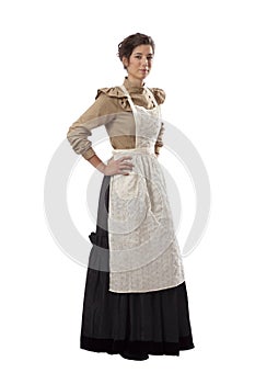 Young prairie woman with hands on hips and wearing an apron isolated on white