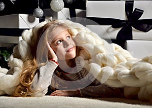 Young preety girl lying near new year christmas tree under big h