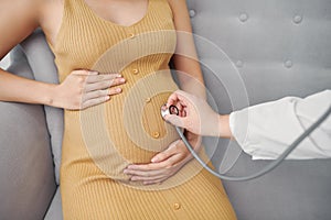 Young preganant woman expecting a baby doctor visit