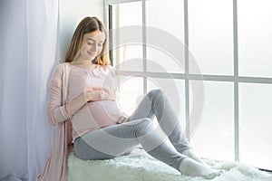 Young preganant woman expecting a baby happy parent