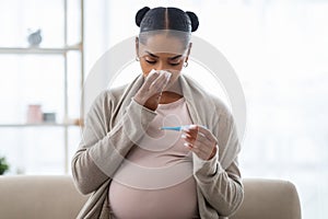 Young pregnant african american woman feeling sick with high fever