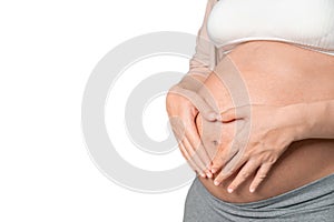 Young pregnant asian woman touching her belly and make heart  shape, she holding baby in pregnant belly isolate on white