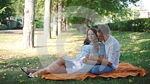 Young Pregnant Couple in the Autumn Park