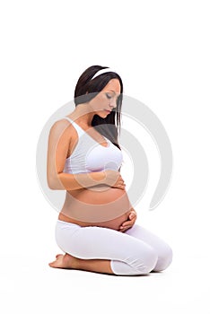 Young pregnant girl sitting quietly. Healthy and Beautiful Pregnancy