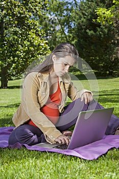 Young pregnant with laptop