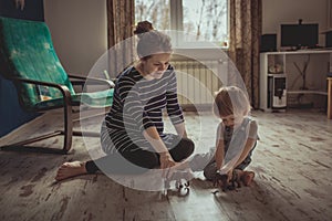 Young pregnant mother and son playing on floor, lifestyle,