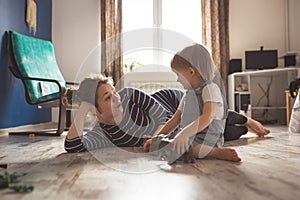 Young pregnant mother and son playing on floor, lifestyle,