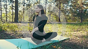 Young pregnant woman doing yoga outside.