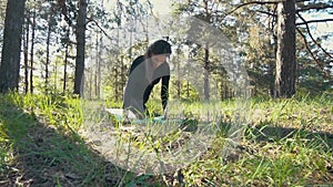 Young pregnant woman doing yoga outside.