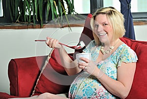 Young pregnant woman - eating ice cream