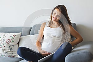 Young pregnant woman, having painful contraction, starting labor