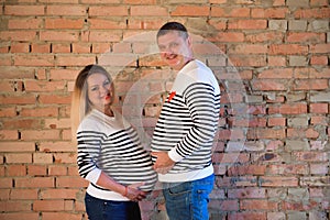 Young pregnant woman with her family, studio shoot