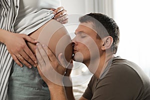 Young pregnant woman with her husband, closeup