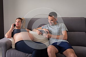 Young pregnant woman with her husband expecting the baby