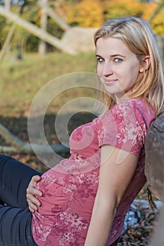 Young pregnant woman is holding her pregnancy belly