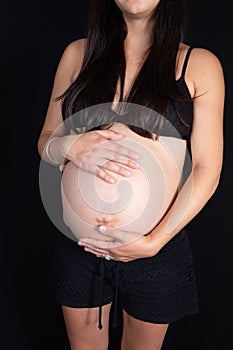 Young pregnant woman holding her stomach in Healthy pregnancy concept