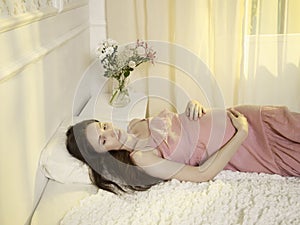 Young pregnant woman in home interior