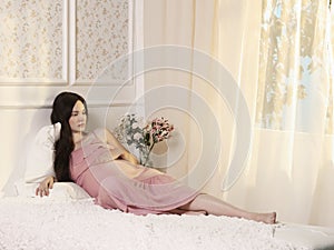 Young pregnant woman in home interior