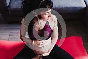 young pregnant woman at home practicing yoga sport. healthy lifestyle