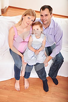 Young pregnant woman, with husband and little daughter