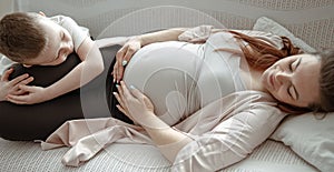 A young pregnant woman lies on the couch with her little son in an embrace