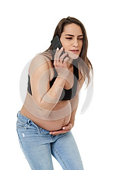 Young pregnant woman on phone with her doctor