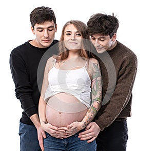 Young pregnant woman posing with two young man on a white background