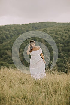 Young pregnant woman relaxing outside in nature