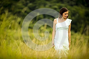 Young pregnant woman relaxing outside in nature