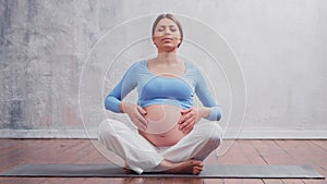 Young pregnant woman is resting at home and expecting a baby. The concept of pregnancy, motherhood, health and lifestyle