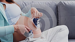 Young pregnant woman is resting at home and expecting a baby. The concept of pregnancy, motherhood, health and lifestyle