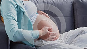 Young pregnant woman is resting at home and expecting a baby. The concept of pregnancy, motherhood, health and lifestyle