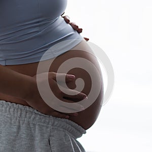 Young pregnant woman is resting at home and expecting a baby. Pregnancy, motherhood, health care and lifestyle concept.