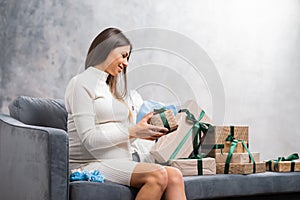 Young pregnant woman is resting at home and expecting a baby. Pregnancy, motherhood, health care and lifestyle concept.