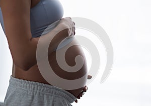 Young pregnant woman is resting at home and expecting a baby. Pregnancy, motherhood, health care and lifestyle concept.